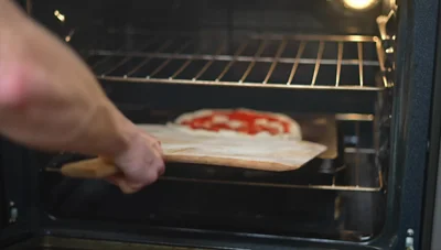 The baking tray method yields a pizza with good crispness, comparable to the pizza stone, but not as good as the baking steel.