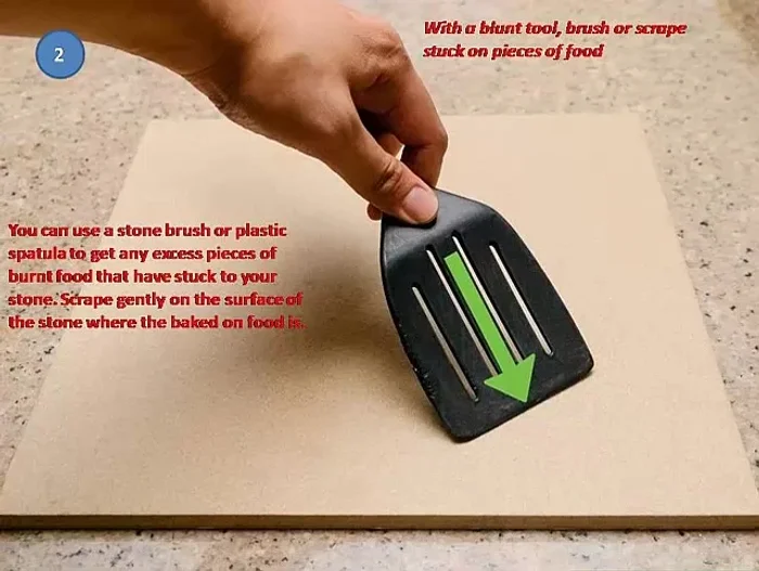 Use a blunt tool or brush to scrape off stuck-on food. A stone brush or plastic spatula works well. Scrape gently to avoid damaging the stone.