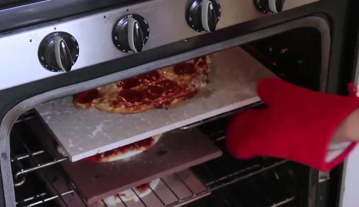 Bake pizzas on the preheated tiles.