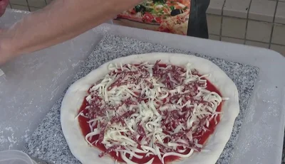 Add toppings: salami, New York style pizza sauce, Neapolitan pizza sauce, mozzarella, and parmigiano.