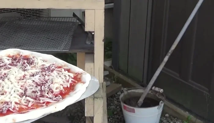 Slide the pizza onto the hot pizza stone in the oven using the peel.