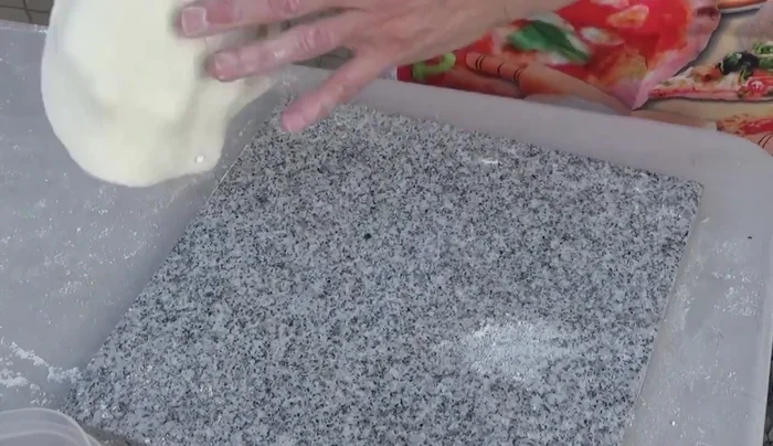 Prepare the pizza ingredients: salami, New York style pizza sauce, Neapolitan pizza sauce, freshly grated whole milk mozzarella, and parmigiano.