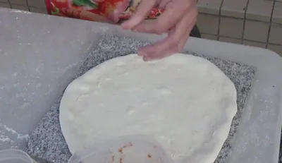 Add toppings: salami, New York style pizza sauce, Neapolitan pizza sauce, mozzarella, and parmigiano.