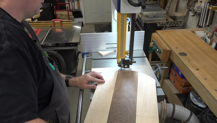 Cut the shape: Cut out the pizza peel shape on the bandsaw, slightly outside the marked lines, leaving room for sanding.