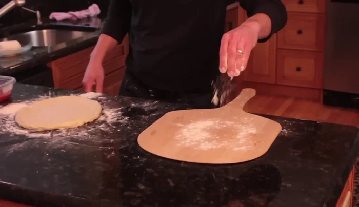 Use a gentle jerking motion to help the dough slide onto the peel.