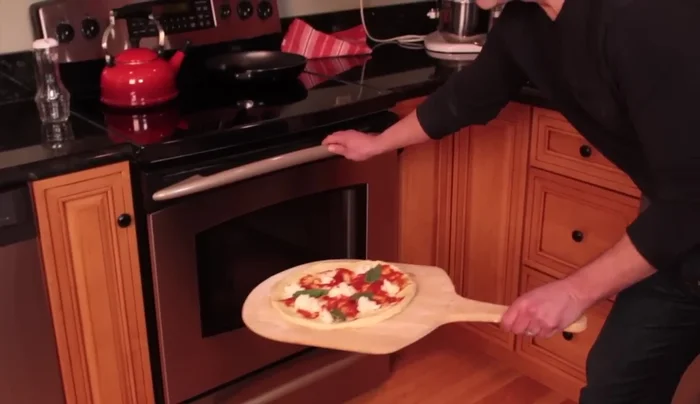 Carefully remove the peel from the oven.