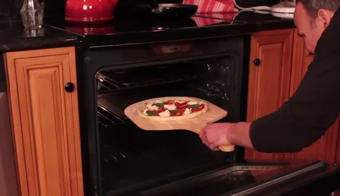 Carefully remove the peel from the oven.