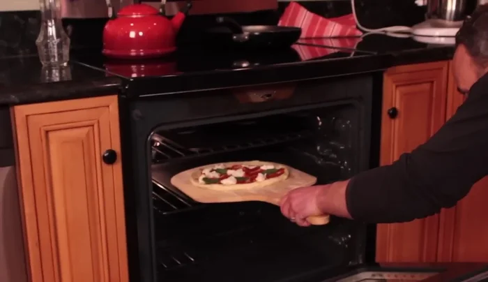 Carefully remove the peel from the oven.