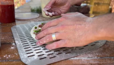 Calzonify (if all else fails): If the dough remains hopelessly stuck, transform it into a calzone by folding it over, creating slits for air release.