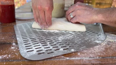 Calzonify (if all else fails): If the dough remains hopelessly stuck, transform it into a calzone by folding it over, creating slits for air release.