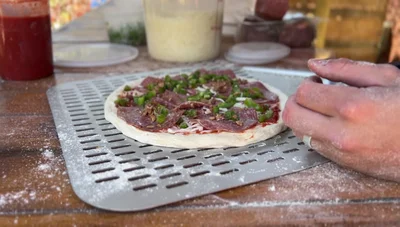 Calzonify (if all else fails): If the dough remains hopelessly stuck, transform it into a calzone by folding it over, creating slits for air release.