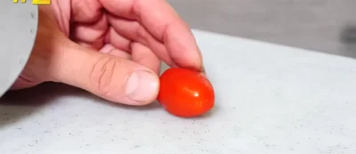 Slice coriander, olives, and feta cheese for a salad.