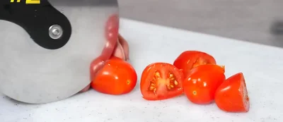 Slice coriander, olives, and feta cheese for a salad.