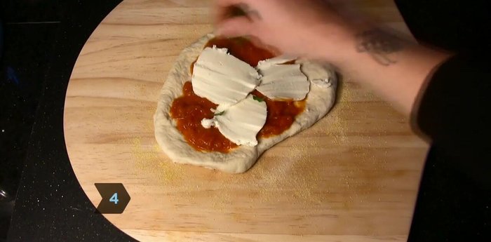 Slide the pizza onto the hot stone and cook for 10 minutes.