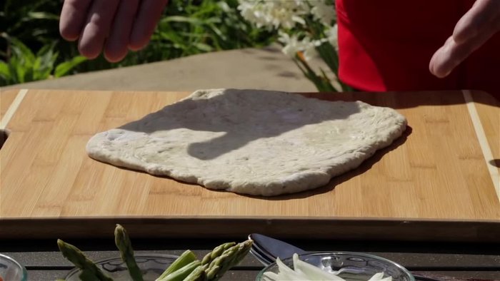 Prepare your pizza dough; take it out of the fridge 30-45 minutes beforehand to make stretching easier.