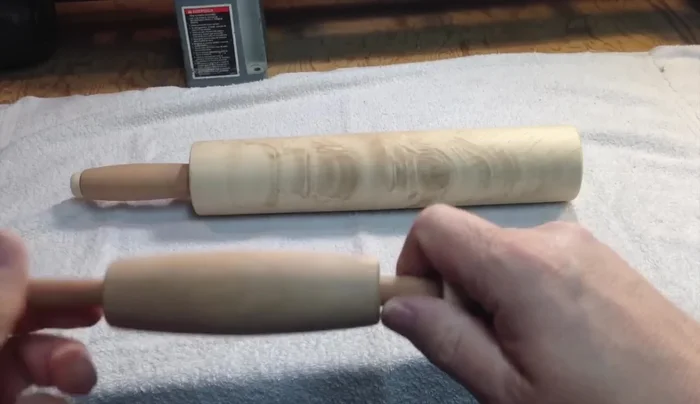 Assemble the rolling pin. Apply glue to the ends of the dowel pins and insert them into the main cylinder, leaving a small gap for rotation. Apply wax for lubrication.