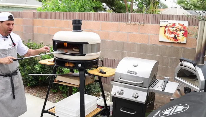 Monitor the pizza's bottom. If it's cooking too fast, use the peel to lift and reposition the pizza away from the direct heat. If the top isn't cooking fast enough, move the pizza closer to the heat source.