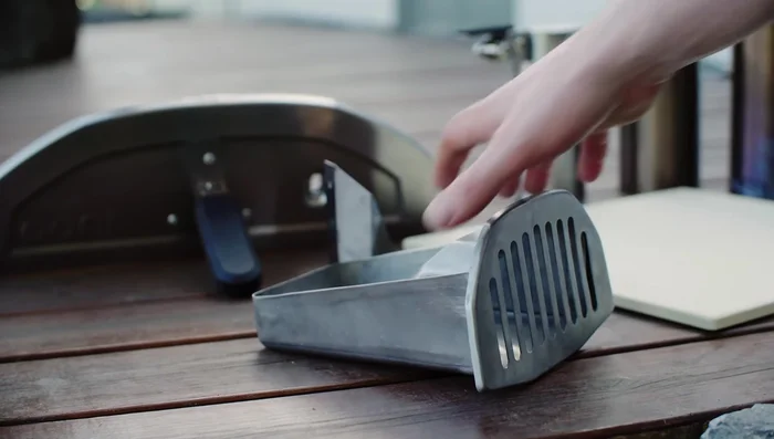 Insert the stone baking board and flame keeper.