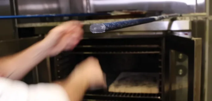 Place the pre-cooked dough on the preheated steel plate.