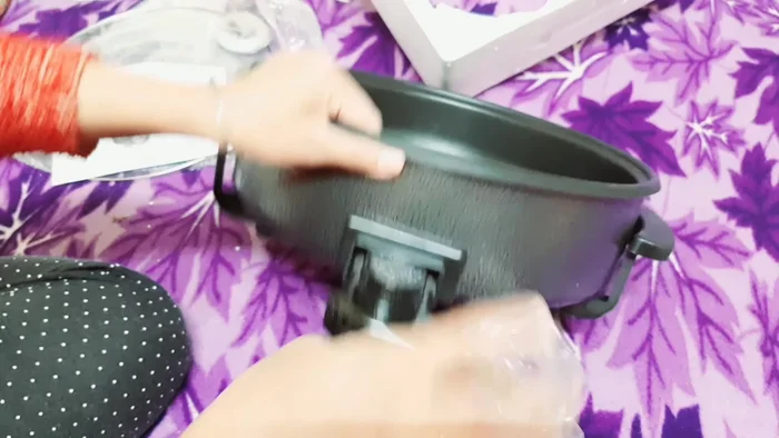 Connect the power cord. Remember to turn on the power switch *after* the pan is set up to prevent electrical hazards.