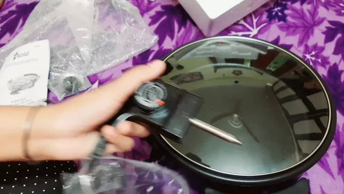 Cook your food. The video mentions many possibilities: pizza, biscuits, vegetables, rice, sweets (kheer, halwa), chilla, uttapam, and even dal (though this isn't recommended for prolonged boiling in a non-stick pan).