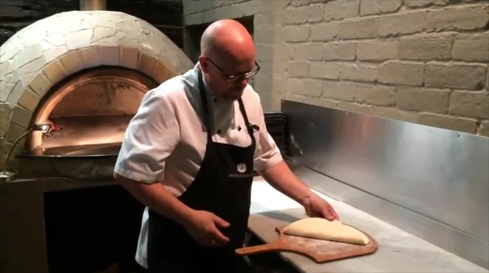 Add toppings (example: Wacky Meatball pizza with homemade BBQ sauce, Wagyu brisket, mozzarella).