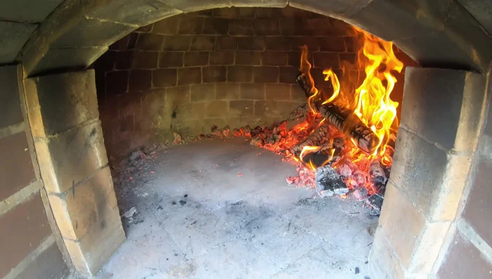 Dampen a mop or cloth and wipe the surface where the pizza will be placed to prevent sticking.