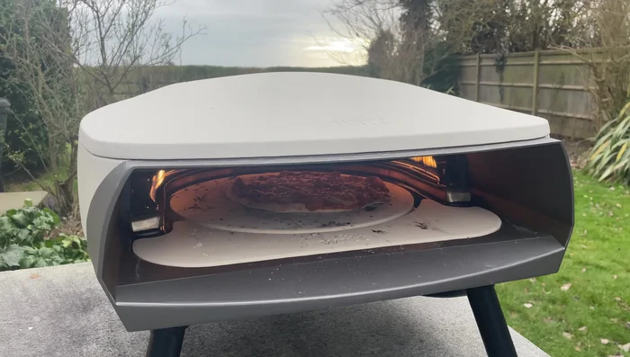Pizza cooking on a pizza stone