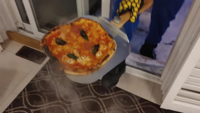 Wood-fired pizza, crisp crust, steaming.
