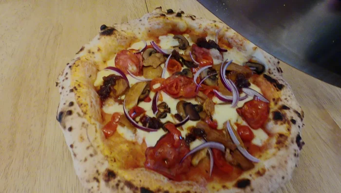 Delicious pizza ready to be sliced.