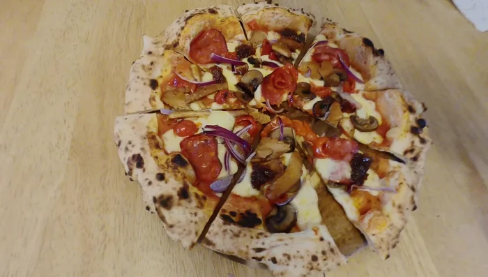 Delicious pizza, ready to be cut.