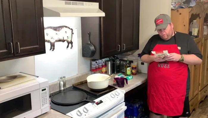 Man preparing pizza dough in kitchen