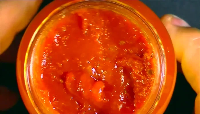 Close-up of tomato sauce in jar.