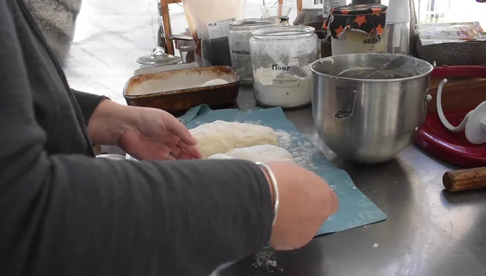 Shaping pizza dough for baking.