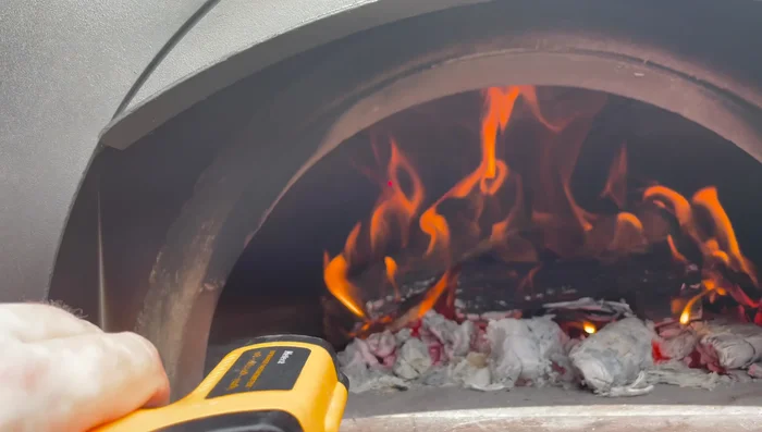 Add another log to maintain temperature if necessary before cooking.