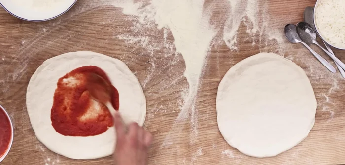 Add sauce, leaving a gap between the crust and sauce. Add cheese and basil.