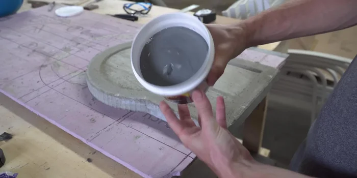 Remove the oven body from its mold and apply a layer of refractory cement to the interior.