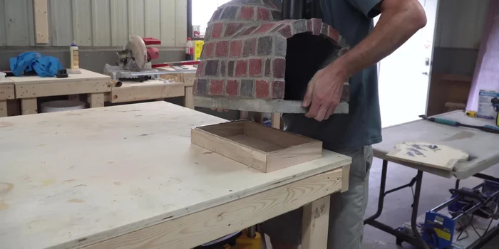 Attach the wooden base to the oven.