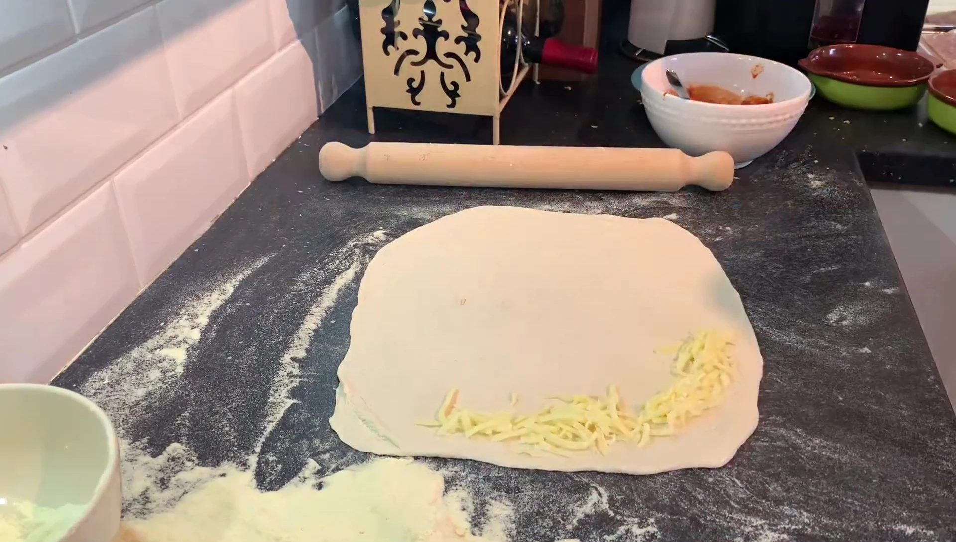 Adding cheese to pizza dough