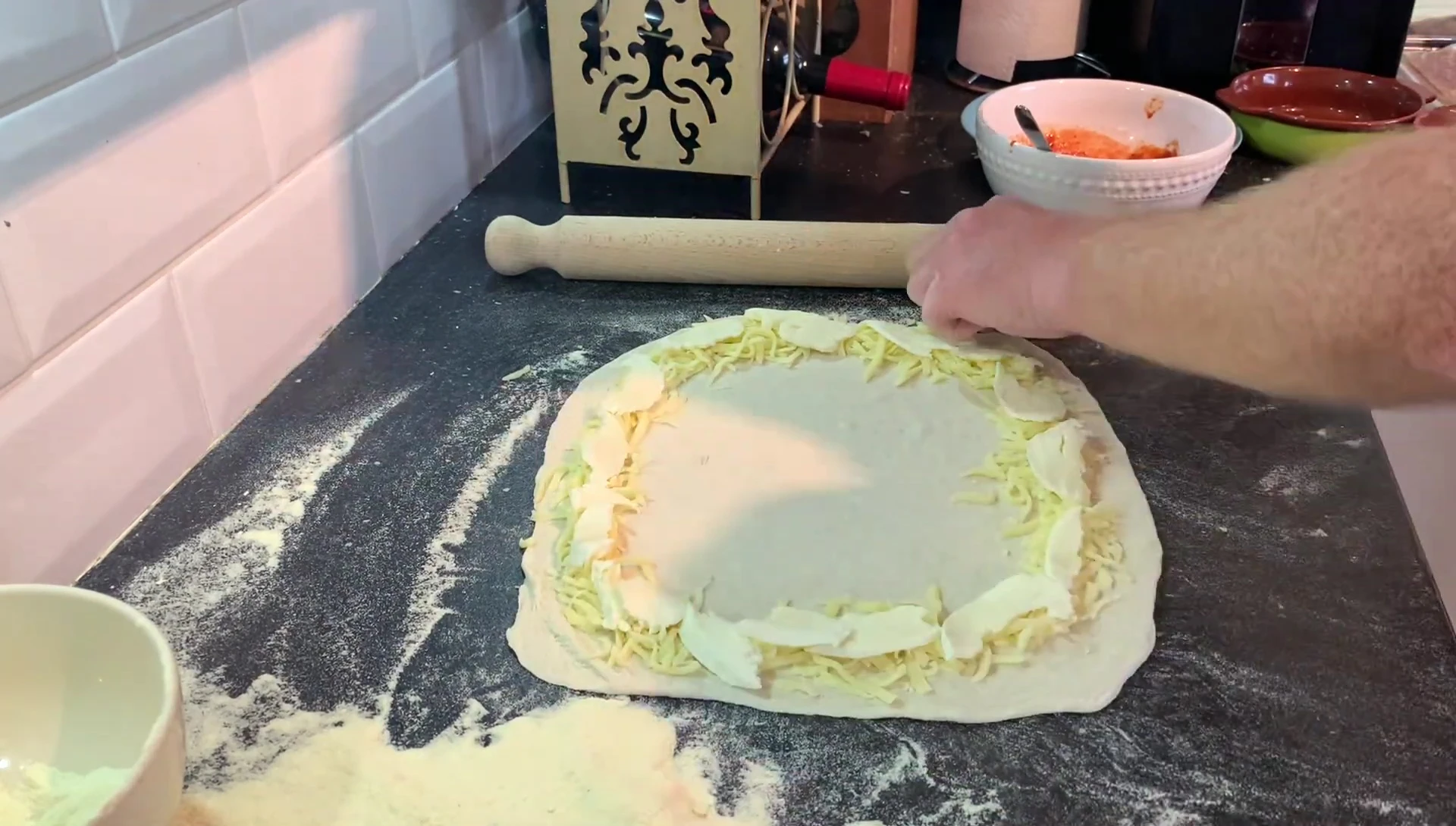 Pizza dough with cheese filling, ready for toppings.