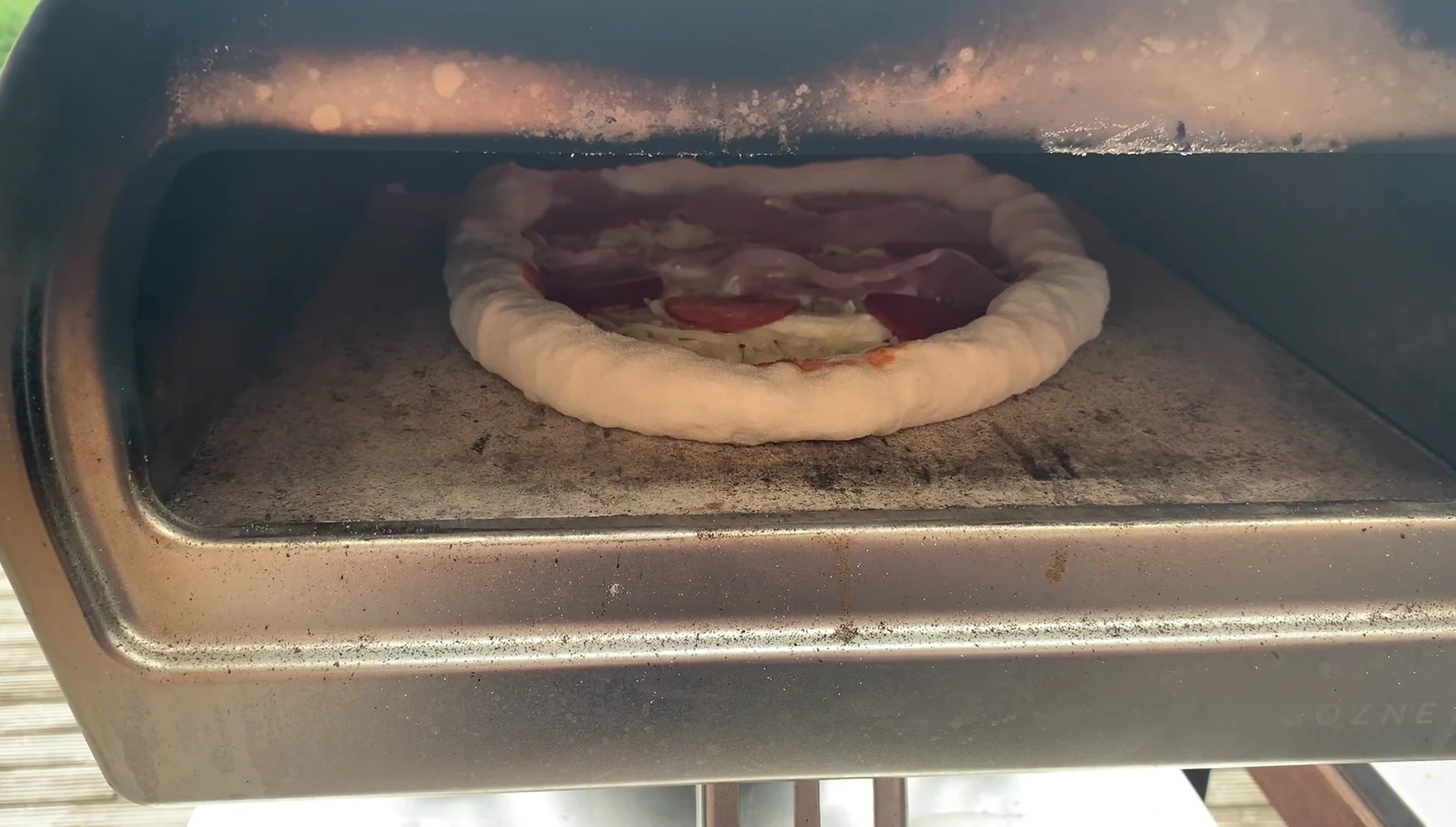 Pizza baking in a wood-fired oven
