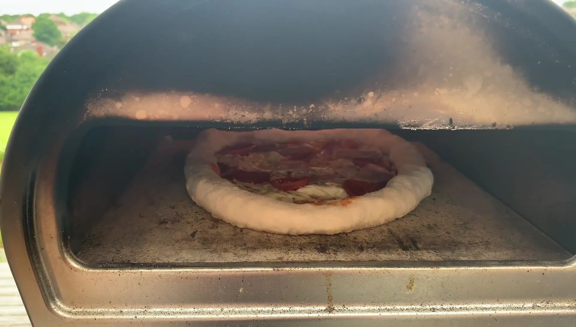 Pizza baking in a wood-fired oven