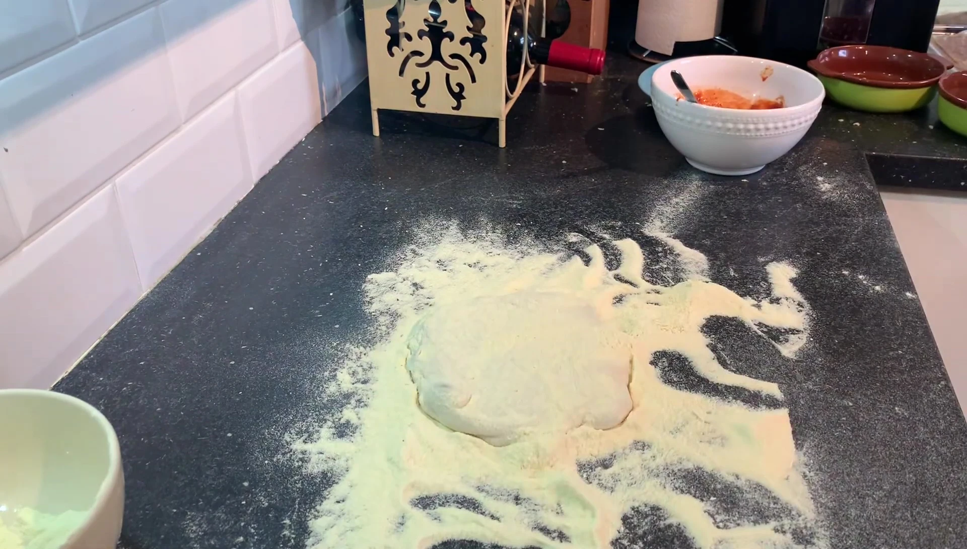 Pizza dough rolled out on floured surface