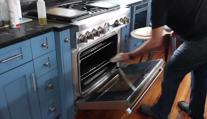 The launch: With confidence and using the 'Jimmy' motion, slide the pizza onto the hot steel in the oven.