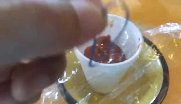 Secure the plastic wrap with a rubber band.