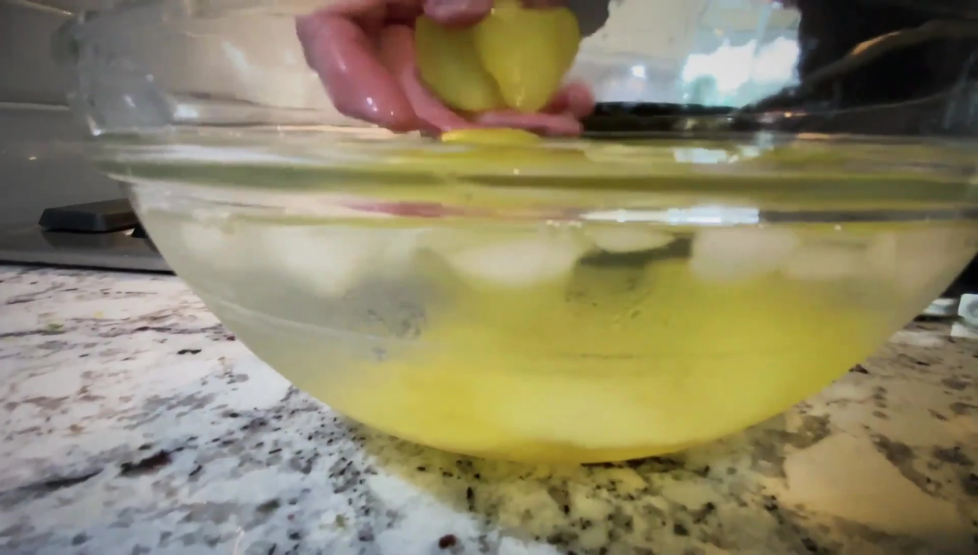 Potatoes being patted dry on a paper towel.