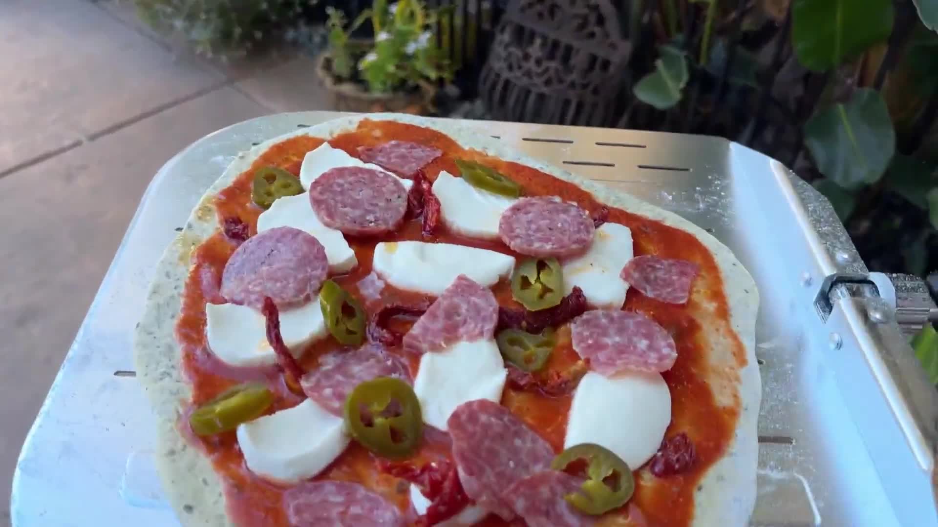 Close-up shot of the pizza toppings being prepared.