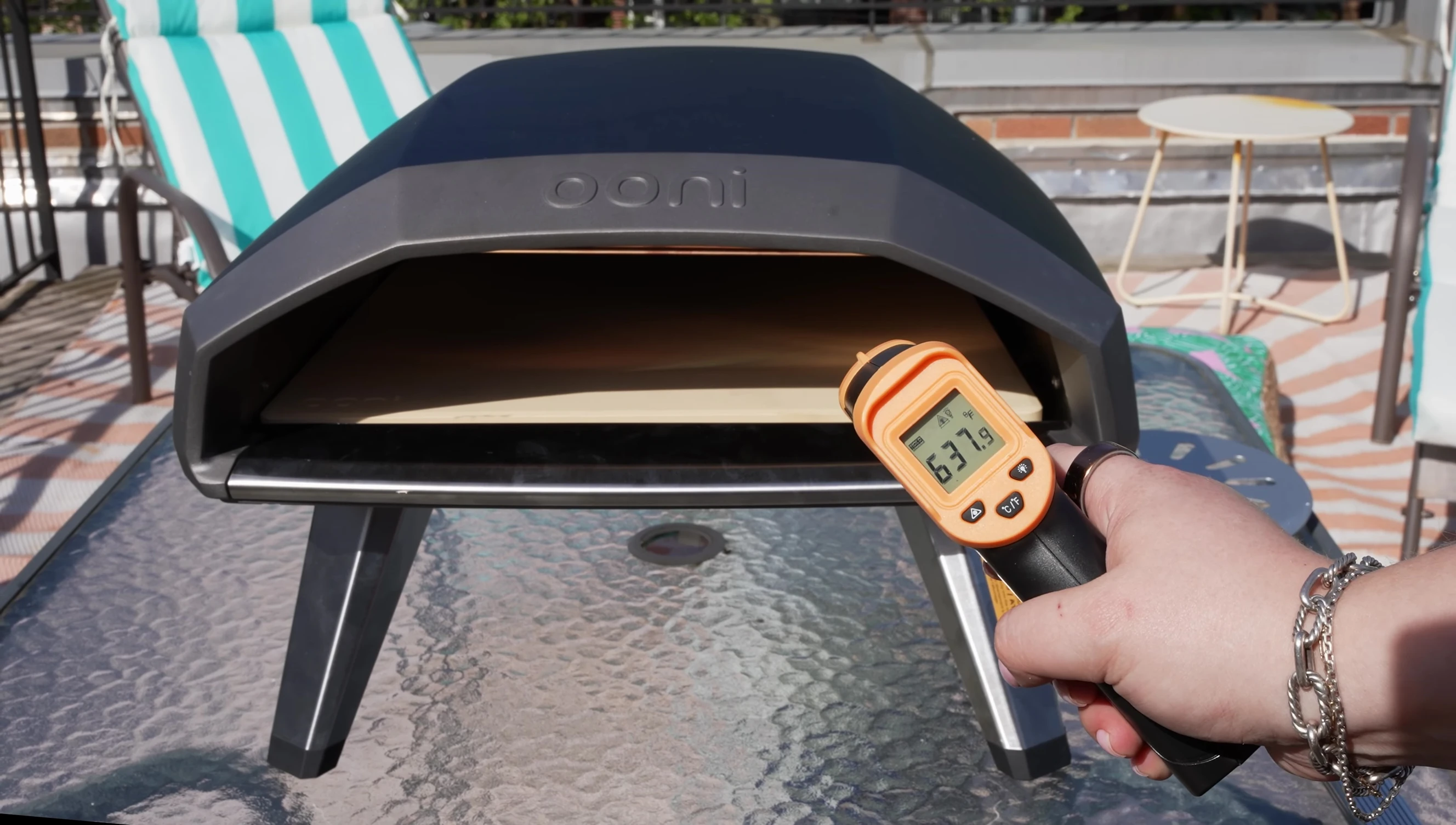 Temperature gun reading the temperature of the pizza stone.