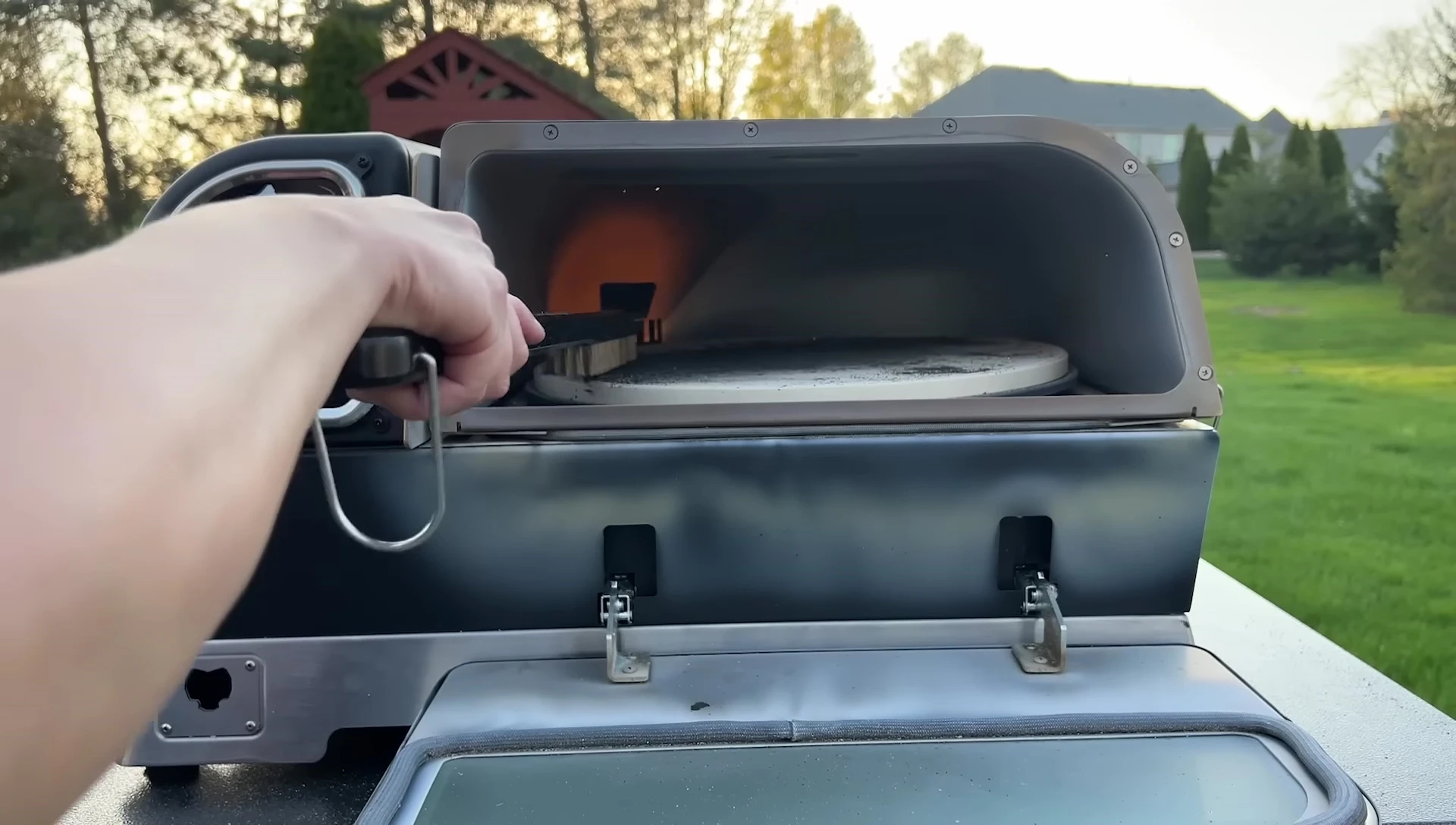 Using tools to clean the pizza stone.