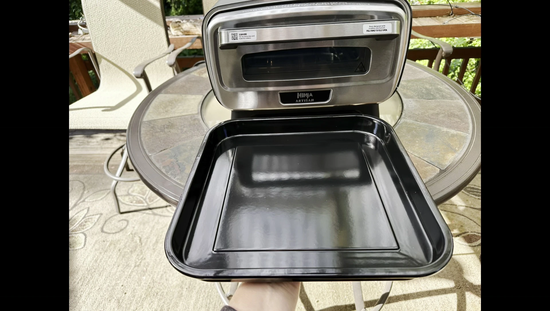 The oven positioned outdoors, showcasing its weather resistance.